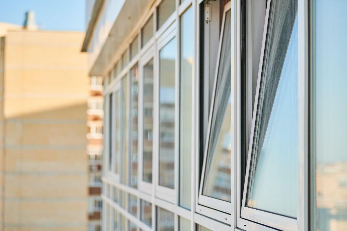 white aluminum window opened to prevent rising energy bills