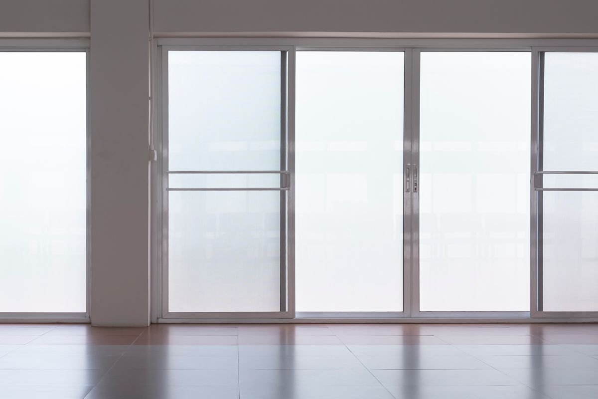 Aluminum sliding glass doors in a bright interior, showing large panels suited for typhoon-season protection
