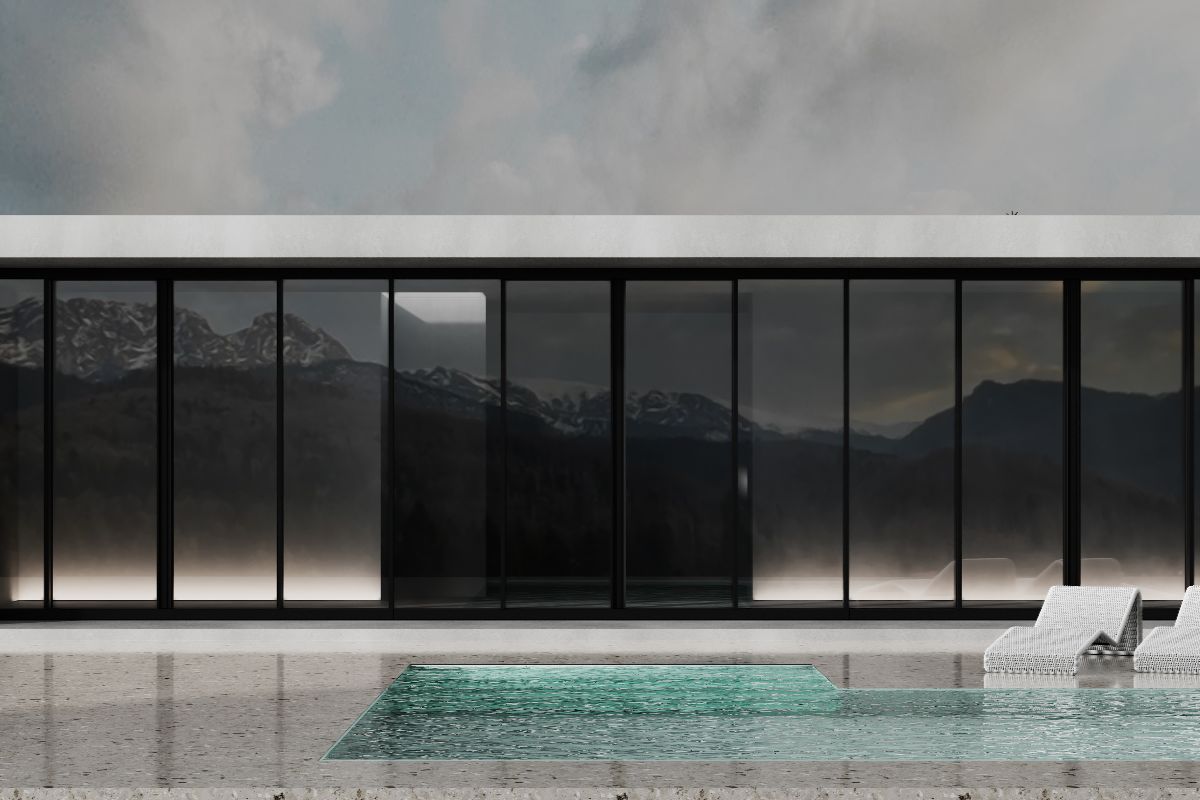 Modern building with slim black aluminium sliding doors facing a pool and mountain view