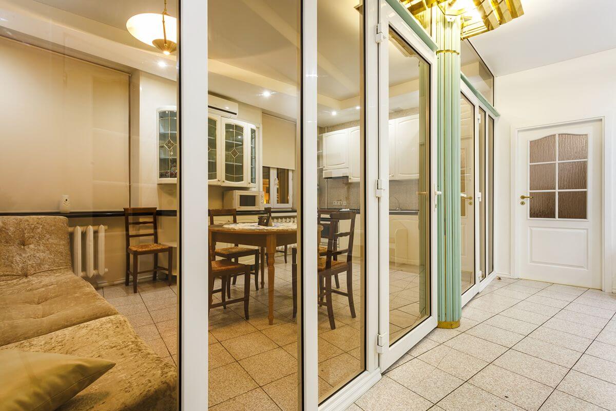 Aluminum glass sliding doors separating indoor living and dining spaces in a modern home