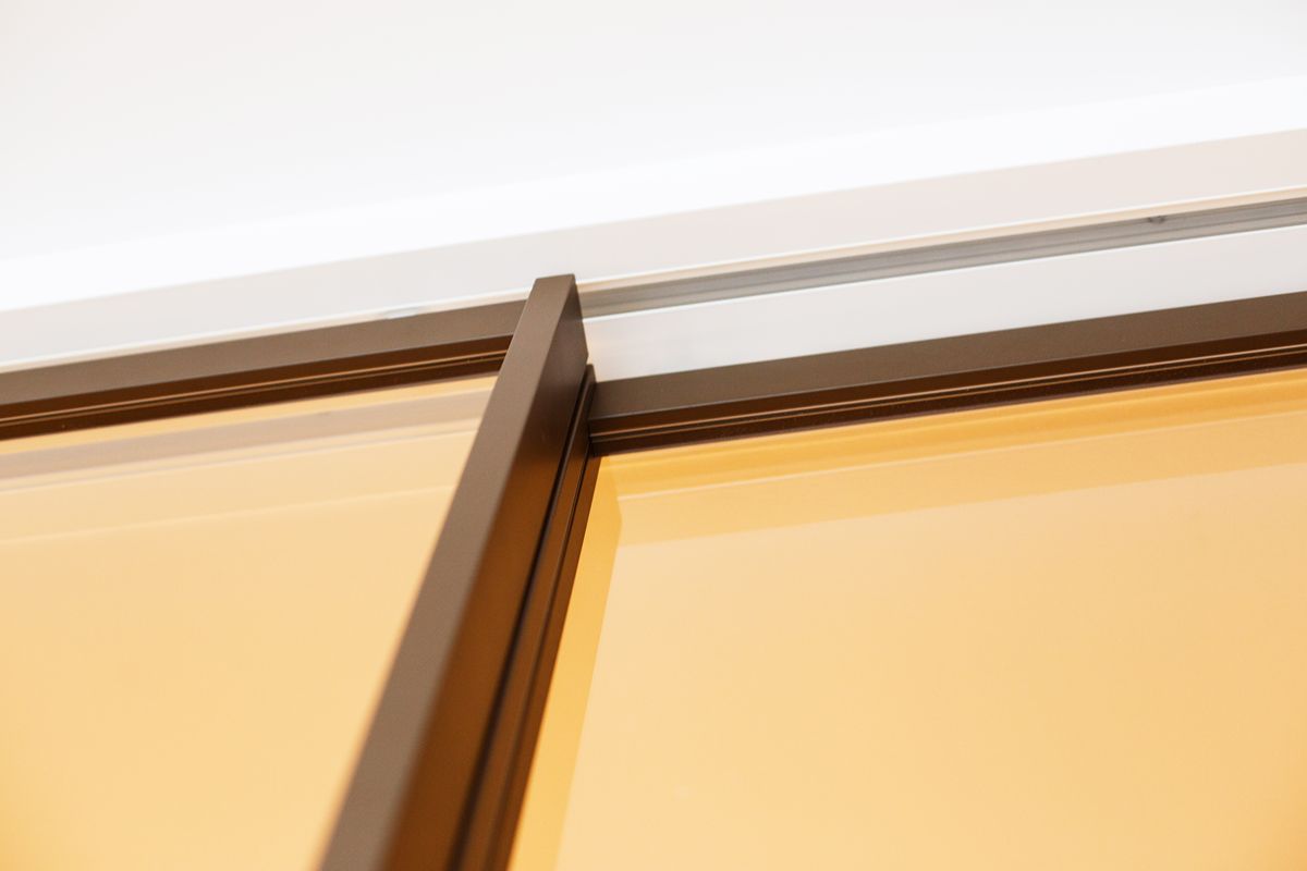 Close-up of aluminum sliding door framing showing structural support for large glass panels