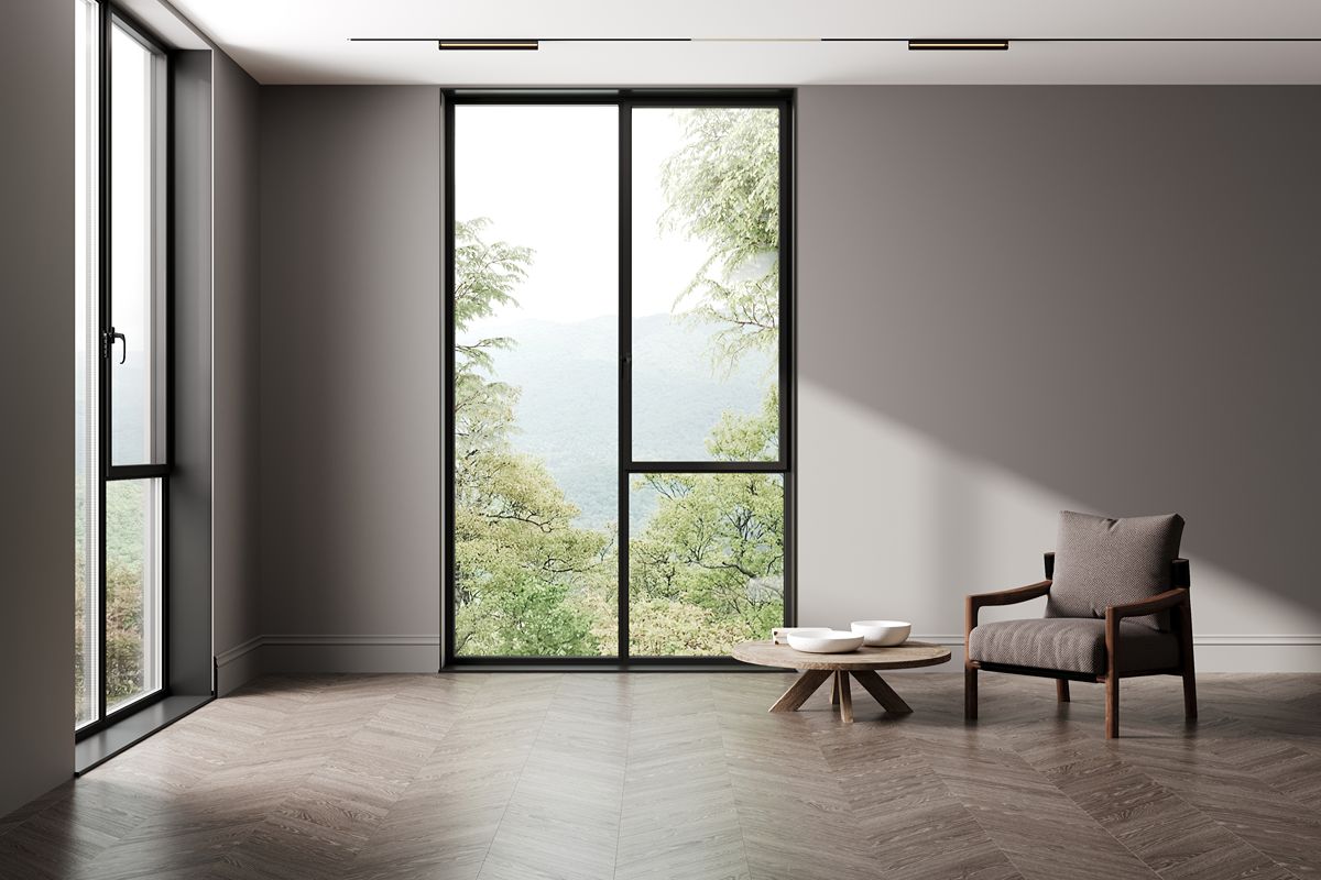 Minimalist room with slim black awning window frames, large glass panels, and natural outdoor views