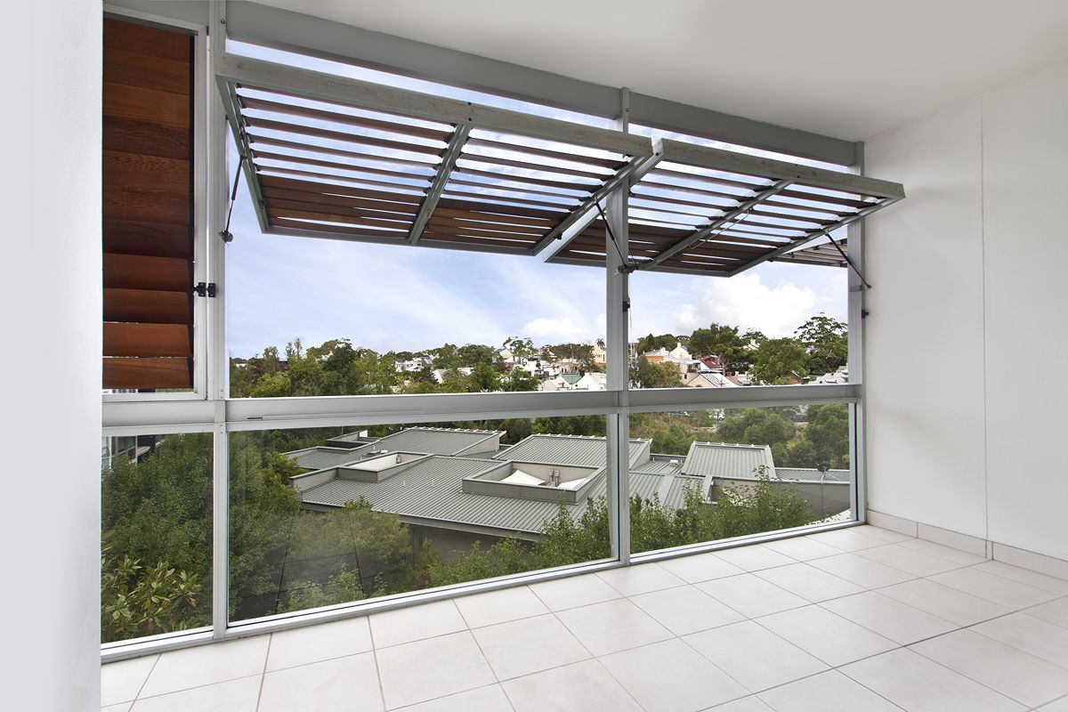 Large aluminum-framed awning windows opened outward to provide natural ventilation and outdoor views